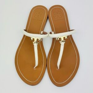 Tory Burch T-strap white leather sandals. Gold-tone logo charm. Size 8.5